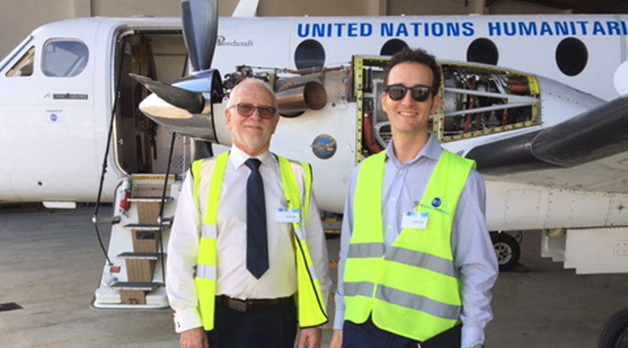 employees in front of a humanitarian aircraft