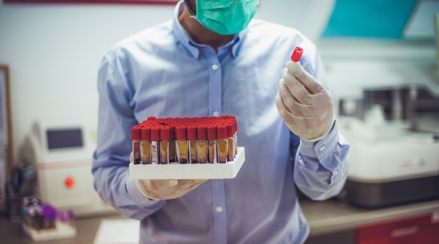 a man with bottles in a laboratory