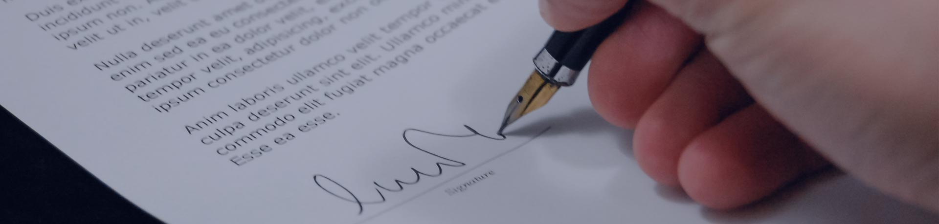 hand with a pen doing its signature on a contract