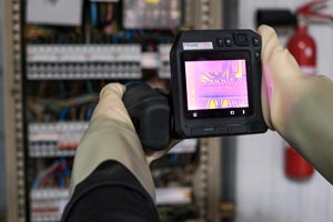 thermographer inspecting an electrical panel