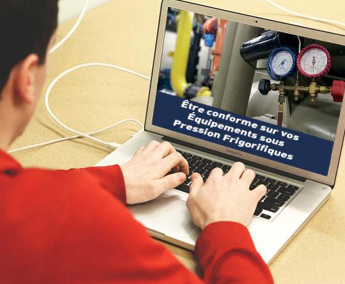 Un homme devant son ordinateur en train de regarder une photo d'un équipement sous pression