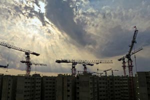 cranes on a building site against a background of sunset