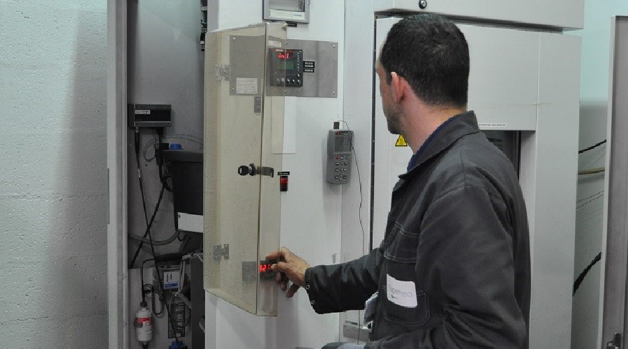 A maintenance technician working on a climatic chamber