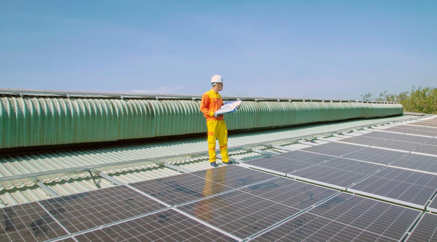 An Apave Engineer on inspection with solar panels