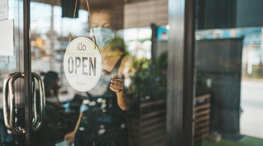 A shop door with the Open logo