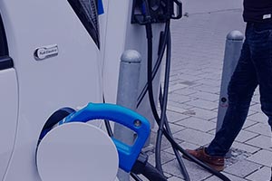 man charging his electric vehicle