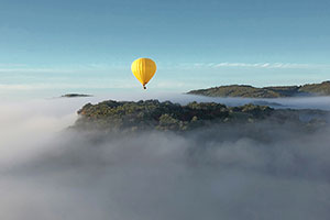 a hot air balloon above the clouds
