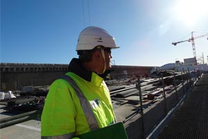 a man with an Apave helmet on a construction site